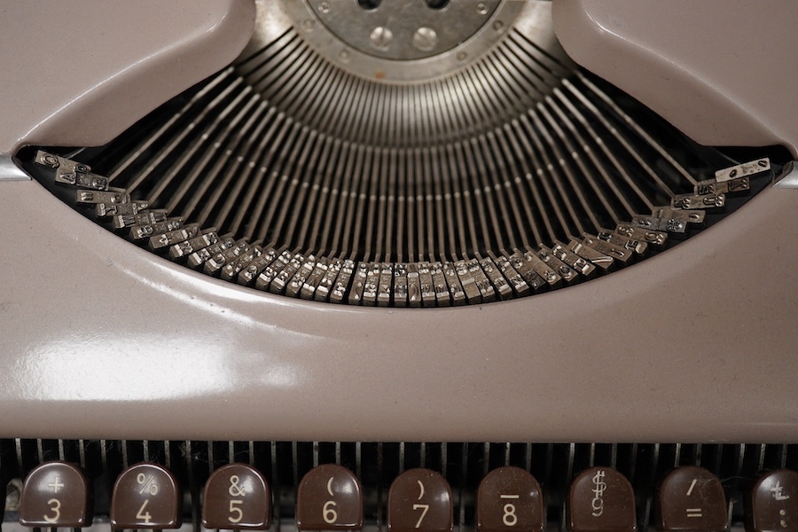 Three cased typewriters; a German Gossen Tippa, a Remington Travel-Riter and a German (U.S. Zone) Blue Bird. Condition - fair to good.